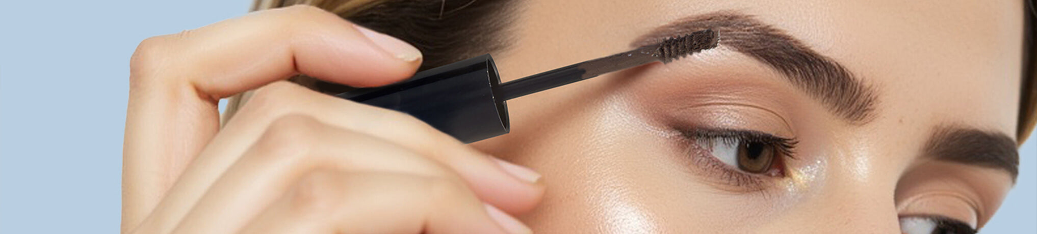 close-up of a girl applying colored eyebrow mascara