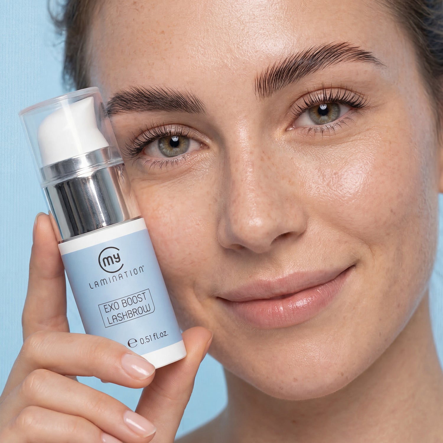 a smiling model holding an Exo Boost Lashbrow