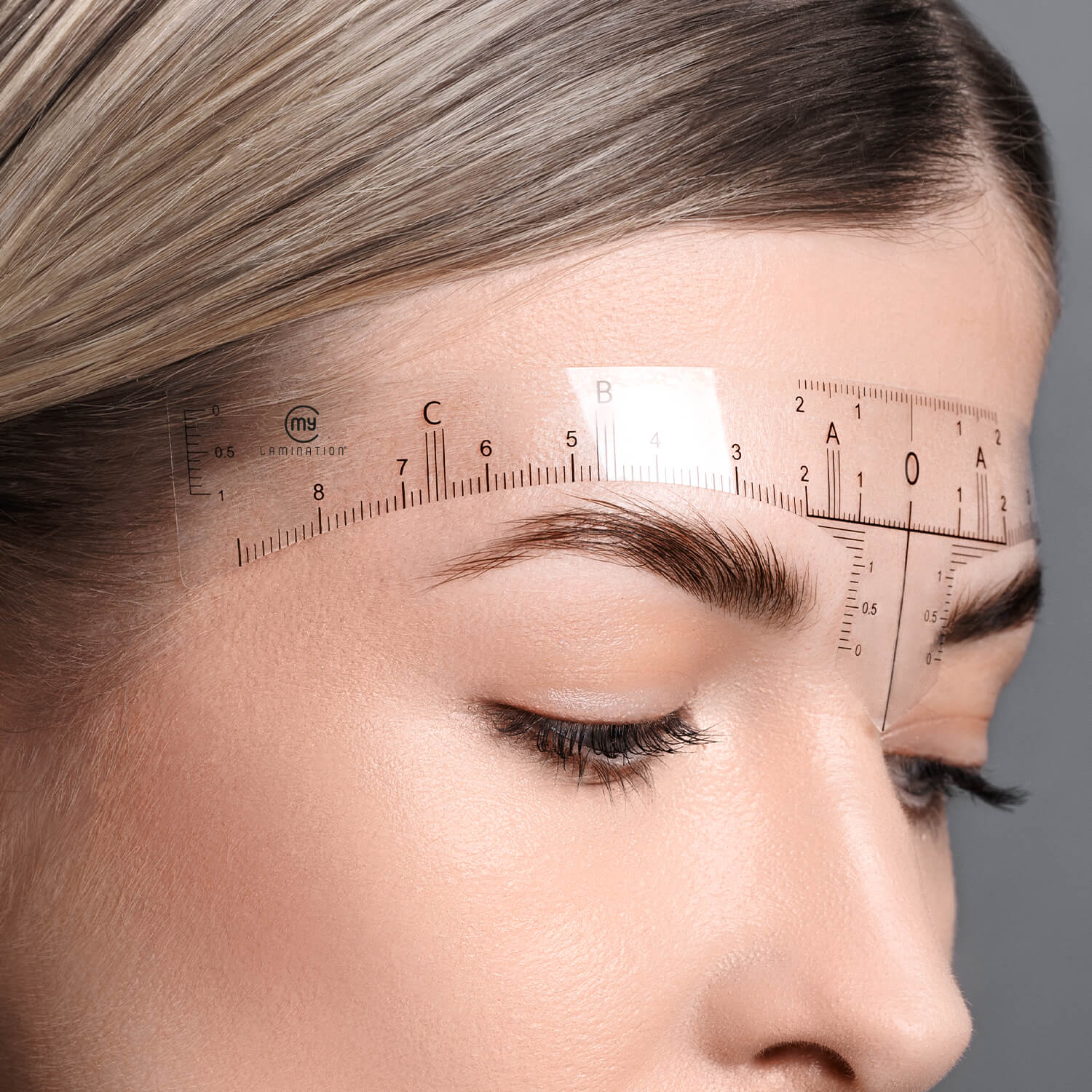 eyebrow ruler applied to a model's forehead